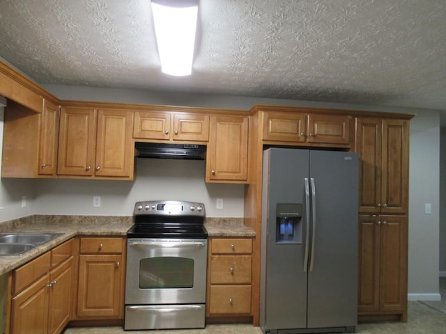 152 Royal Oaks Ln, Dahlonega, GA 30533 - kitchen featuring appliances with stainless steel finishes, under cabinet range hood, a sink, brown cabinetry, and a textured ceiling
