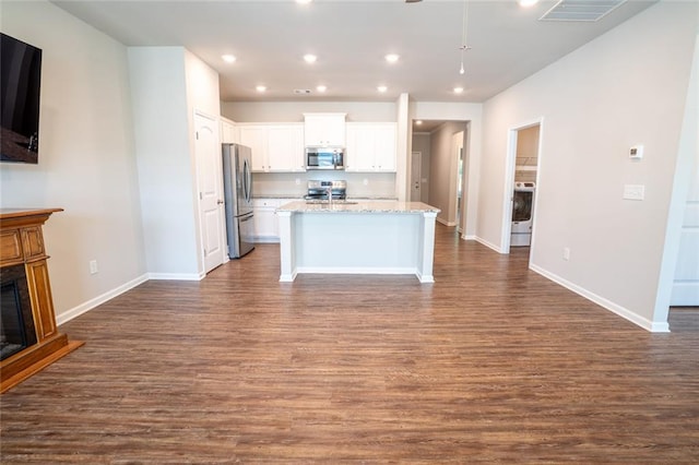 155 Sanctuary Pl, Jasper, GA 30107 - kitchen featuring appliances with stainless steel finishes, dark wood-type flooring, white cabinetry, a fireplace with raised hearth, and recessed lighting