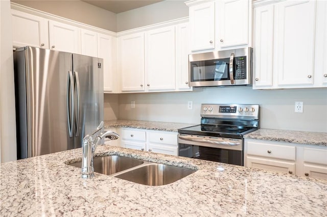 155 Sanctuary Pl, Jasper, GA 30107 - kitchen with appliances with stainless steel finishes, white cabinetry, and light stone counters