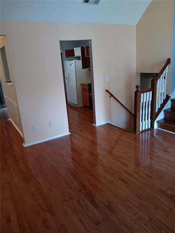 unfurnished living room featuring dark hardwood / wood-style flooring