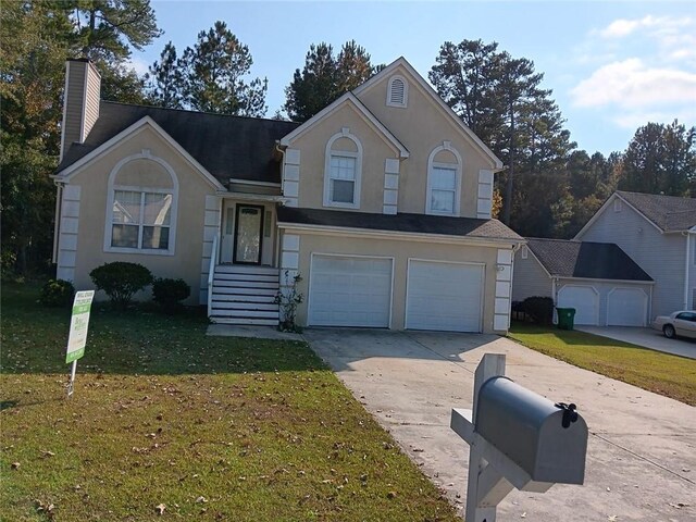 view of front property with a front yard and a garage