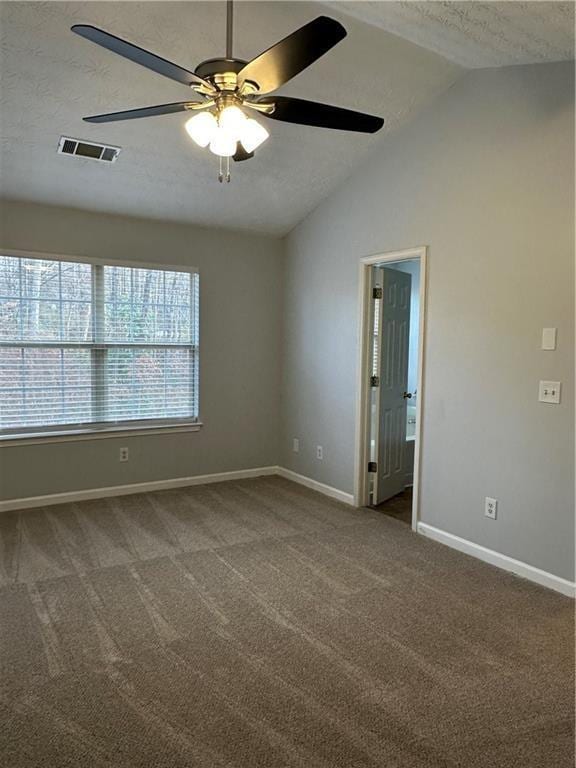 unfurnished room with ceiling fan, lofted ceiling, carpet flooring, and a textured ceiling