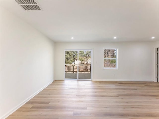 unfurnished room featuring light wood-type flooring, baseboards, visible vents, and recessed lighting