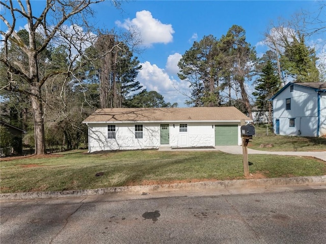 ranch-style home featuring an attached garage, a front yard, and concrete driveway