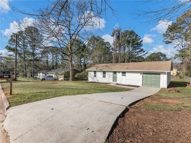 ranch-style house with driveway, a front yard, and a garage