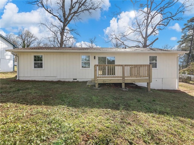 rear view of house featuring a lawn, crawl space, and a deck