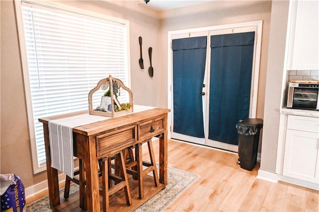 entryway with light wood-type flooring and baseboards