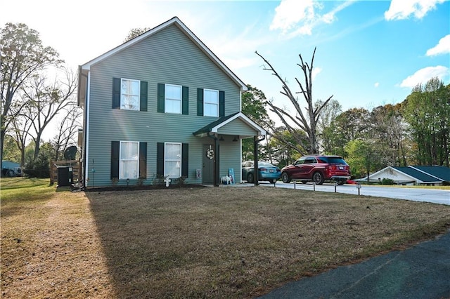 view of front of home with a front yard and central air condition unit