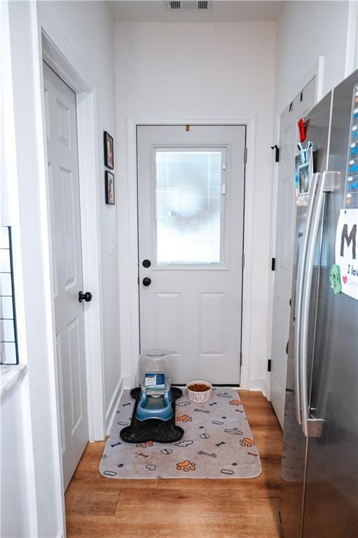 entryway with light wood-type flooring and visible vents