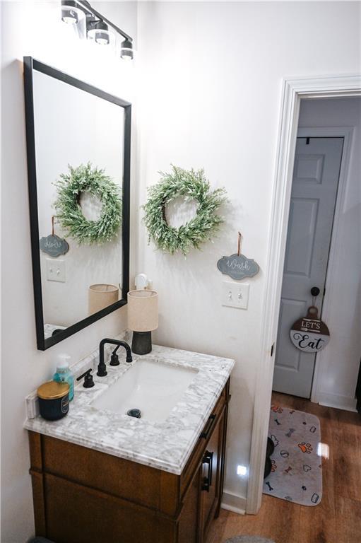 bathroom with wood finished floors and vanity