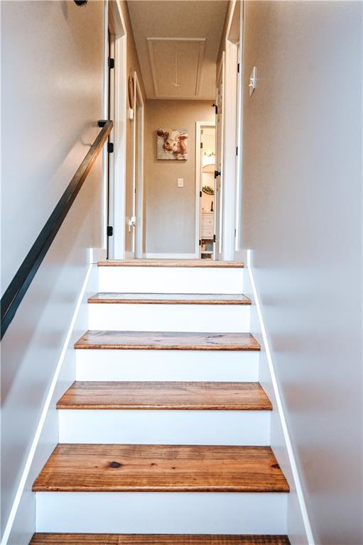 stairway featuring attic access