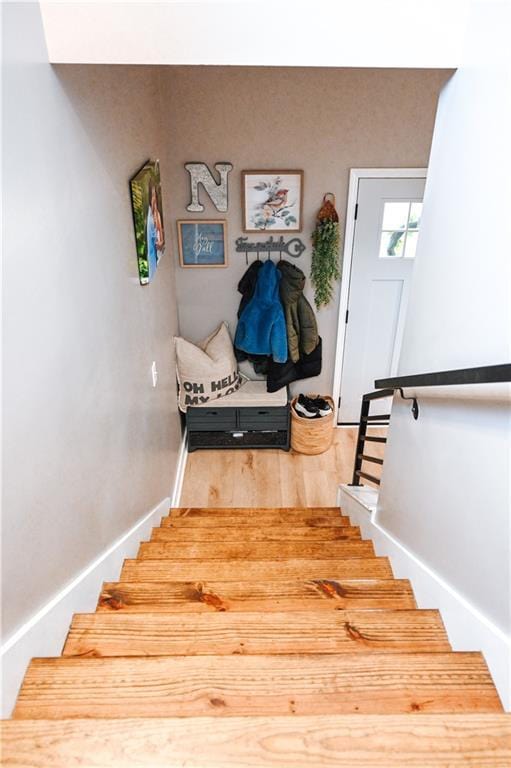 stairs featuring baseboards and wood finished floors