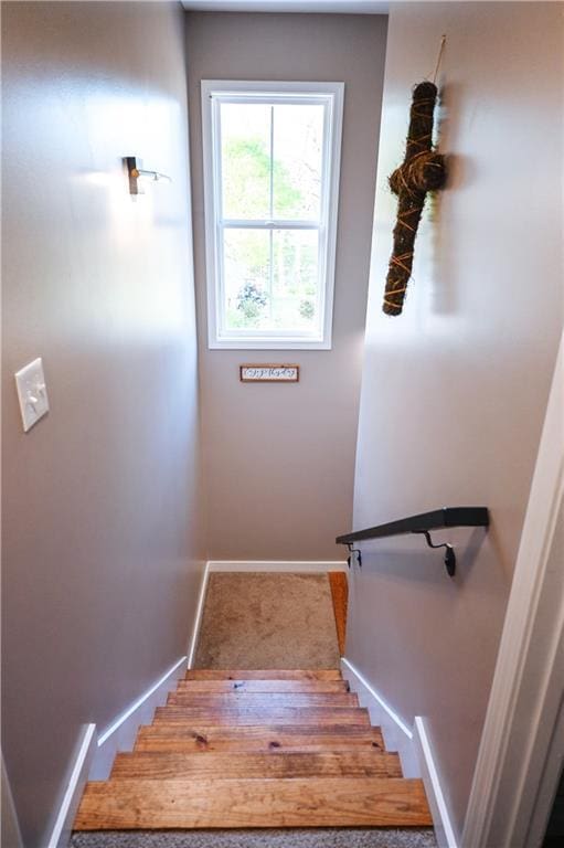 staircase featuring baseboards