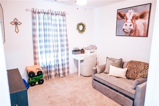 sitting room featuring ceiling fan and carpet flooring