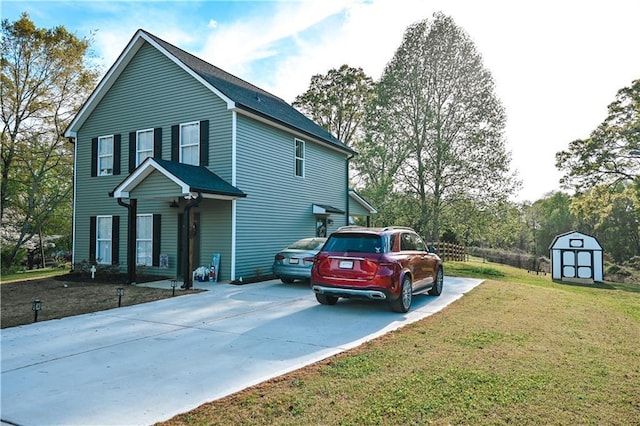 view of side of home with concrete driveway, an outdoor structure, a yard, and a storage shed