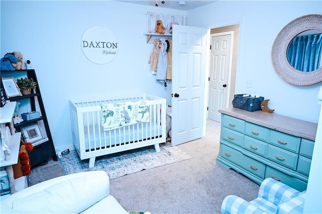 carpeted bedroom with a crib