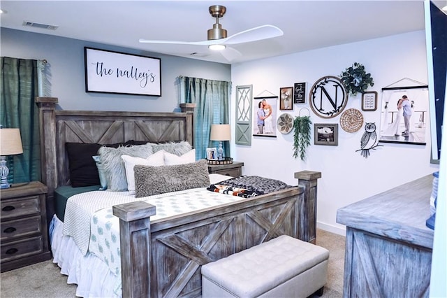 carpeted bedroom featuring ceiling fan, baseboards, and visible vents