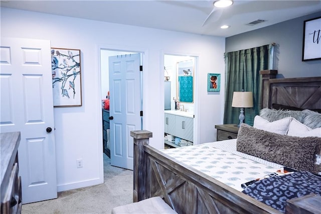 bedroom featuring light carpet, baseboards, ensuite bath, visible vents, and recessed lighting