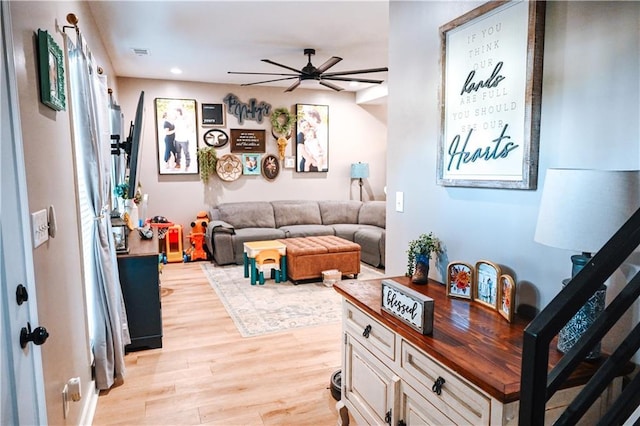 living area featuring visible vents, recessed lighting, light wood-style floors, stairway, and ceiling fan