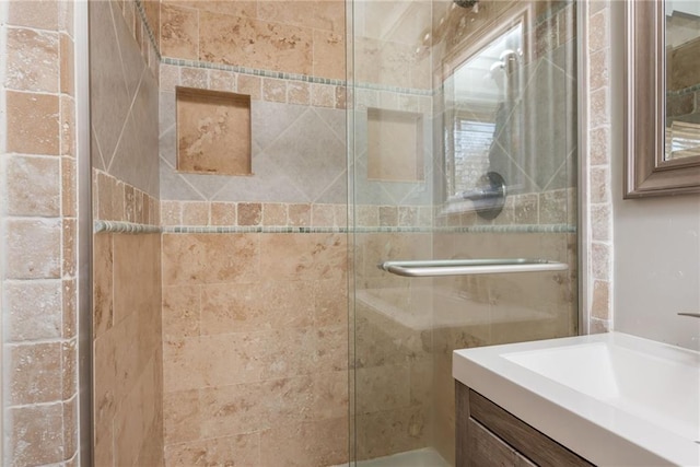 full bathroom featuring a stall shower and vanity