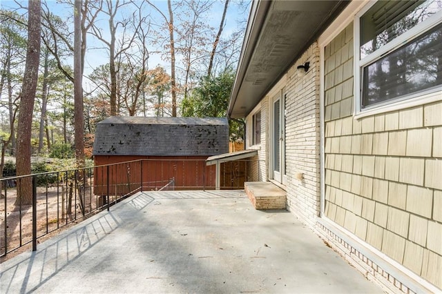 view of patio / terrace featuring an outbuilding and fence