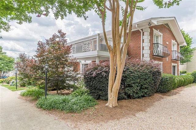 view of property exterior featuring brick siding