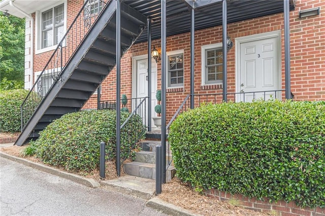 property entrance with brick siding