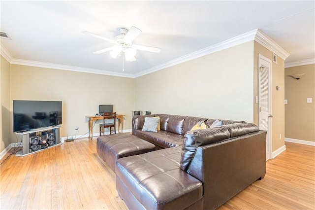 living area with light wood-style floors, crown molding, and baseboards