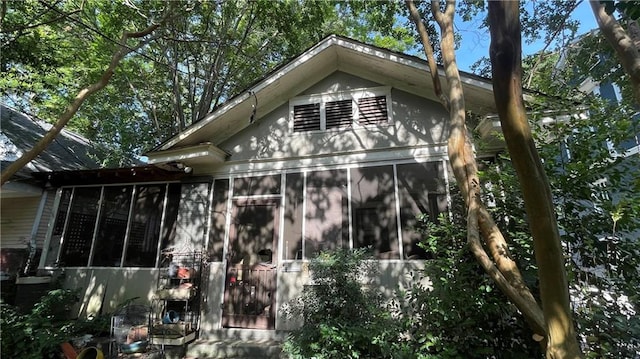 view of side of home featuring a sunroom