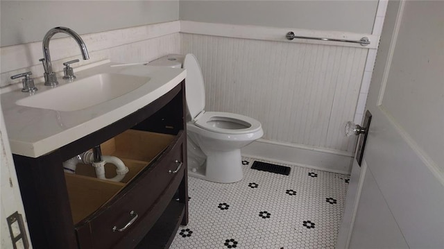 bathroom with tile flooring, vanity, and toilet