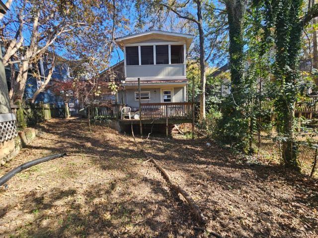 back of property featuring a wooden deck