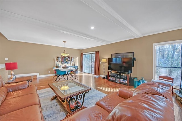 living room featuring beam ceiling and light hardwood / wood-style floors