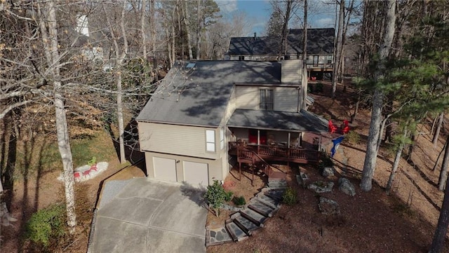 rear view of house featuring a garage and covered porch