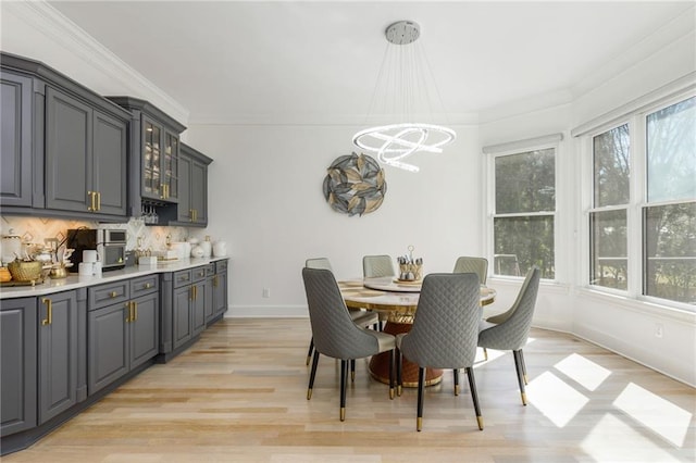 2461 Oak Grove Ests NE, Atlanta, GA 30345 - dining room with a chandelier, light wood finished floors, crown molding, and baseboards