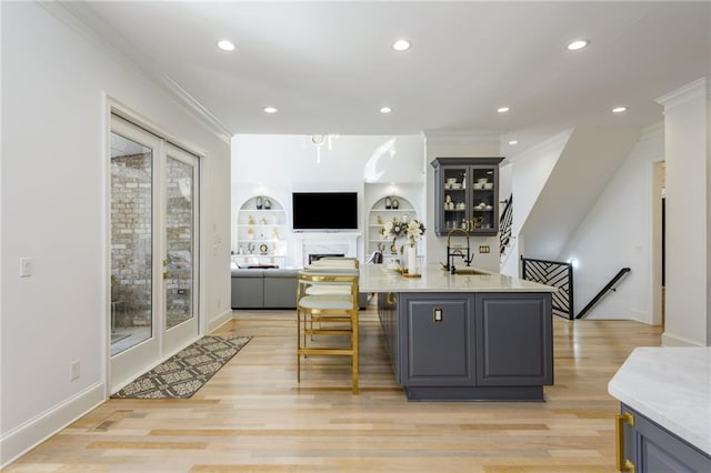 2461 Oak Grove Ests NE, Atlanta, GA 30345 - bar area featuring crown molding, a sink, light wood-style flooring, recessed lighting, and baseboards