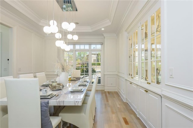 2461 Oak Grove Ests NE, Atlanta, GA 30345 - dining room with a decorative wall, light wood-style floors, crown molding, a chandelier, and a raised ceiling