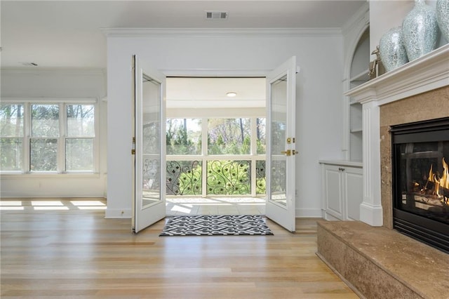 2461 Oak Grove Ests NE, Atlanta, GA 30345 - doorway to outside featuring a premium fireplace, wood finished floors, crown molding, and baseboards