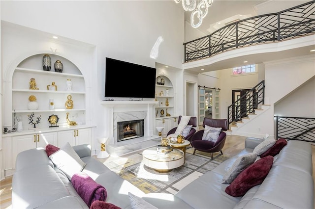 2461 Oak Grove Ests NE, Atlanta, GA 30345 - living room with built in shelves, a towering ceiling, a high end fireplace, stairway, and recessed lighting