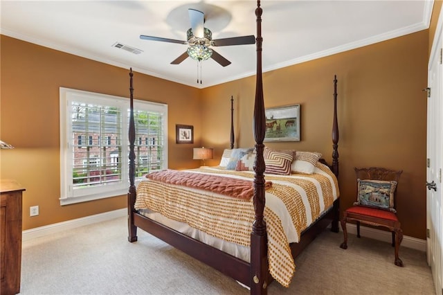 carpeted bedroom with crown molding, baseboards, and a ceiling fan