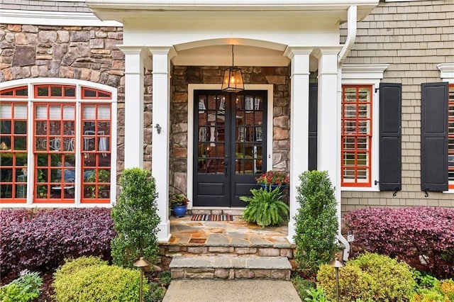 entrance to property featuring french doors and stone siding
