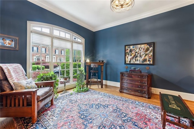 living area featuring wood finished floors, ornamental molding, and baseboards