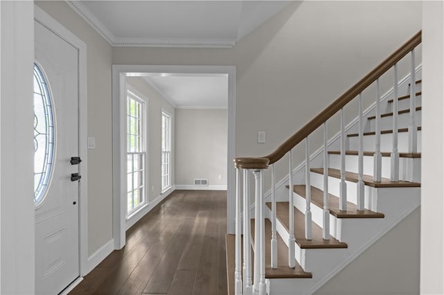 entrance foyer featuring visible vents, baseboards, stairs, dark wood finished floors, and crown molding