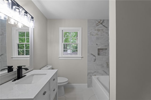 bathroom with marble finish floor, toilet, vanity, and baseboards