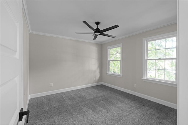 unfurnished room featuring ornamental molding, dark colored carpet, baseboards, and a ceiling fan