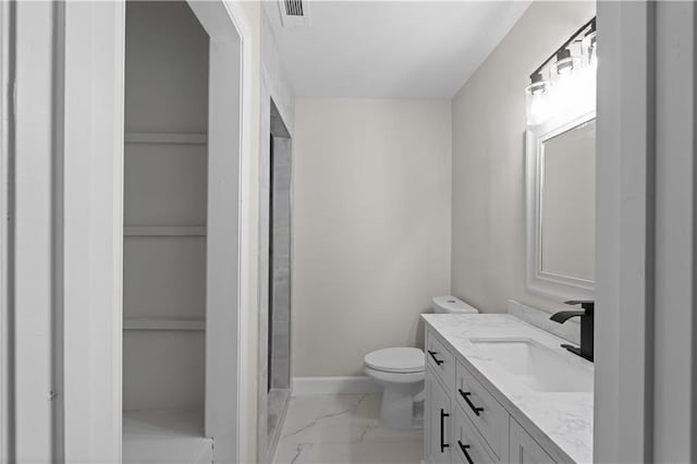 bathroom with marble finish floor, visible vents, toilet, vanity, and baseboards