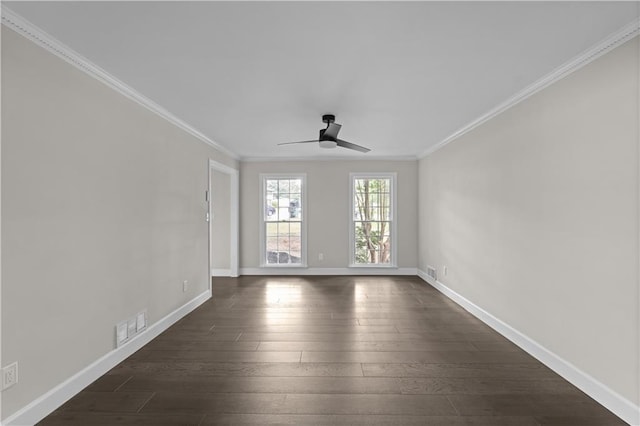 unfurnished room with dark wood-style floors, visible vents, crown molding, and baseboards