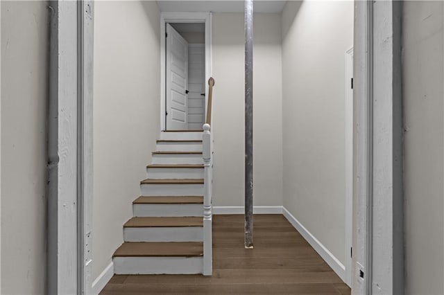 stairway with baseboards and wood finished floors