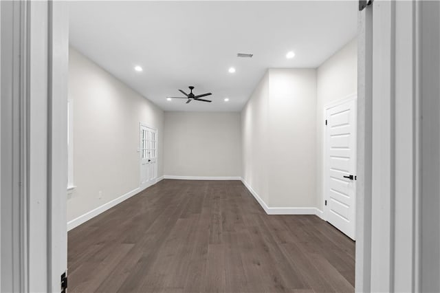 spare room featuring recessed lighting, dark wood-style flooring, visible vents, baseboards, and a ceiling fan