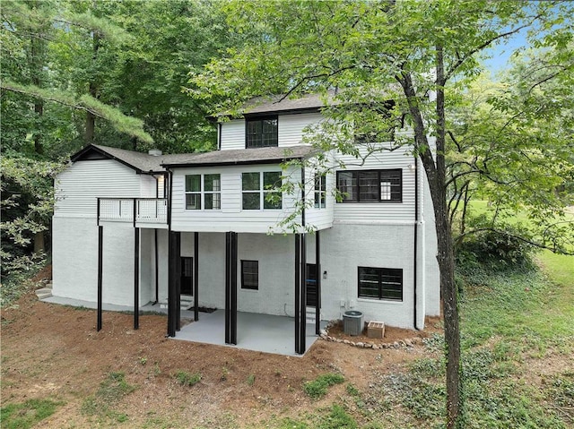 back of property with a patio and central air condition unit