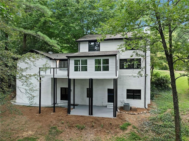 rear view of house featuring cooling unit and a patio area